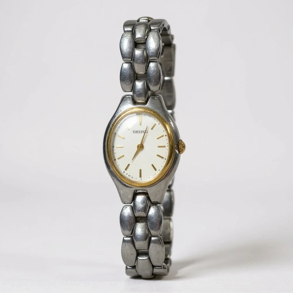 Seiko Oval Women's Two Tone Silver and Gold Wrist  Sunburst Dial Watch 1N00-6F80